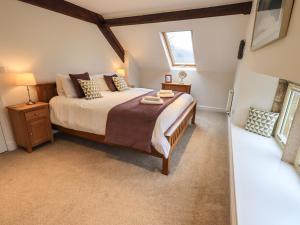 a bedroom with a large bed and a window at Middlerigg in Ambleside
