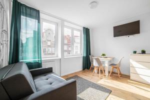 a living room with a couch and a table at Grobla -Old Town by Grand Apartments in Gdańsk