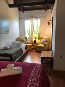 1 dormitorio con 1 cama y sala de estar en Guesthouse Entre Campo y Mar, en La Coronilla