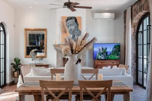 a living room with a table with a vase of flowers at Panoramic Paradise 3BR Gem Overlooking San Miguel in San Miguel de Allende