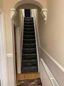 a staircase in a house with a stair case at Cosy Gem in the heart of Glossop in Glossop