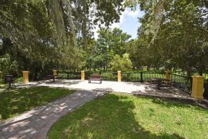 a park with benches and a fence and grass at Lovely Lakeside 4-Bed Pool Home at Villa Sol-3125 in Kissimmee +38 photos