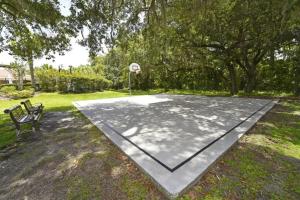 a basketball court in a park with a bench at Lovely Lakeside 4-Bed Pool Home at Villa Sol-3125 in Kissimmee