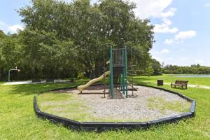 a playground with a slide in a park at Lovely Lakeside 4-Bed Pool Home at Villa Sol-3125 in Kissimmee