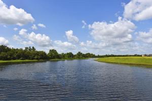 a river under a blue sky with clouds at Lovely Lakeside 4-Bed Pool Home at Villa Sol-3125 in Kissimmee