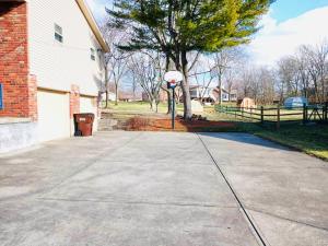 a driveway with a basketball hoop in front of a house at Ocean Palace -12 Guests- close to I-75-Amazing Location!! in Maud