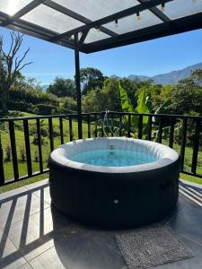a large hot tub on a patio with a view at Glamping La Montañita in Medellín