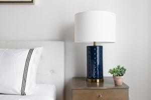 a lamp on a night stand next to a bed at 26-4B Newly Furnished 1BR W D Courtyard in New York