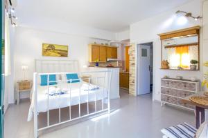 a kitchen and a bedroom with a crib in a room at Vera's Apartments in Kassiopi