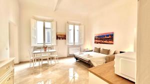 a bedroom with a bed and a table and a couch at Spada & Sole - Boutique Homes in Florence in Florence