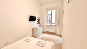 a white room with a dresser and a window at Spada & Sole - Boutique Homes in Florence in Florence