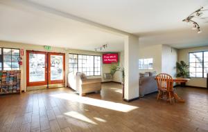 a lobby with a waiting room with a table and chairs at Red Roof Inn Lompoc in Lompoc