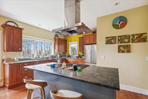 a large kitchen with wooden cabinets and a counter top at Cody's Clubhouse in Waterbury Center
