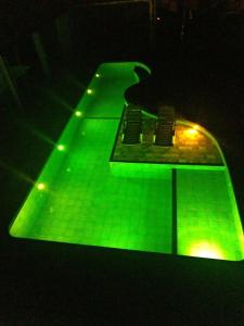 a tennis court with green lights on it at CASA CLUBE EM PENEDO RJ in Itatiaia