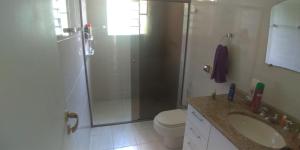 a bathroom with a shower and a toilet and a sink at CASA CLUBE EM PENEDO RJ in Itatiaia