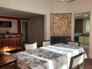 a dining room with a table and chairs and a fireplace at Los manzanares, casa histórica in Veintiocho de Noviembre