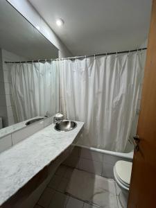 a bathroom with a sink and a toilet and a mirror at Mairea II, Nueva Cordoba in Córdoba