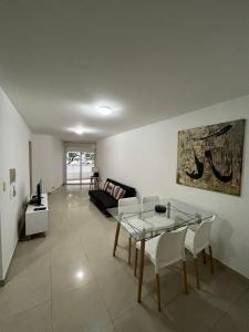 a living room with a table and a couch at Mairea II, Nueva Cordoba in Córdoba
