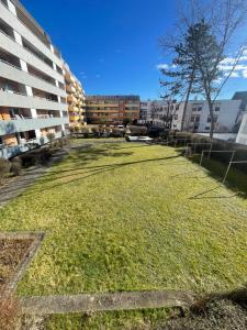 a large grass field in front of a building at Best Apartment Augsburg in Augsburg