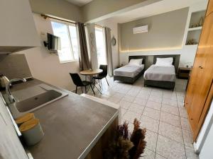 a room with a kitchen and a bedroom with a bed at Ilias Nest 3 in Kardamaina