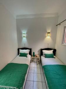 En eller flere senge i et værelse på Les Riads Nour Resorts- Marrakesh Escape