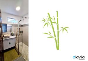 La salle de bains est pourvue d'un lavabo et d'un palmier. dans l'établissement Les Hauts de Devarieux - Sérénité & Horizon, à Garnier