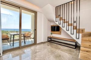 a staircase in a home with a view of the ocean at Aigli Skala Maries Deluxe in Skala Marion