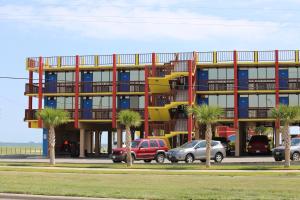 a building with palm trees in front of it at Hotel DeVille in Corpus Christi