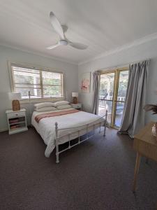 a bedroom with a bed and a large window at Kiarabilli in Bulwer