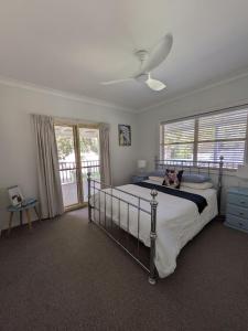 a bedroom with a bed with a dog laying on it at Kiarabilli in Bulwer