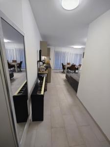 a long hallway with a piano in a room at A côté de l'îles Sion in Sion