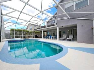 a large swimming pool with a glass ceiling at Elysian deluxe villa in Davenport