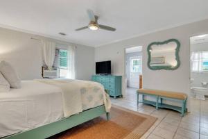 Un dormitorio con una cama, un espejo y un lavabo. en Gem by The Beach Unit B Walk to Beach, Shops, Bars, en Tybee Island