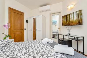 a bedroom with a bed and a desk in it at Hotel la Pietra restaurant in Fosdinovo