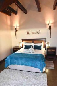 a bedroom with a large bed and two night stands at Hemel op Aarde Villa in Dwarskersbos