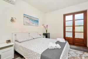 a bedroom with a bed with two towels on it at Hotel la Pietra restaurant in Fosdinovo