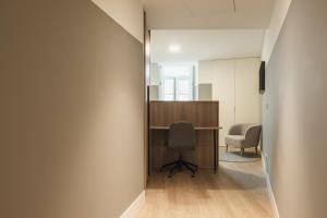 an office with a desk and a chair in a hallway at Apto Ribeira Lisboa in Lisbon