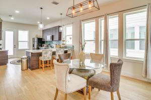 a dining room and kitchen with a glass table and chairs at Upscale San Antonio Condo with Rooftop Patio in San Antonio
