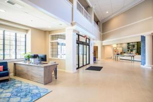 an office lobby with a desk with a computer on it at Hotel Indigo Charleston - Mount Pleasant, an IHG Hotel in Charleston