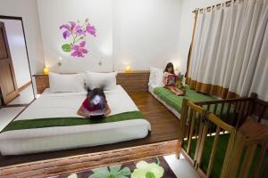 A bed or beds in a room at Thanakha Inle Hotel