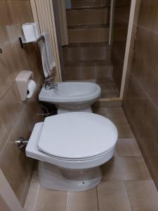 a bathroom with a toilet and a sink at DIMORA VASCO 17 in Monopoli +5 photos