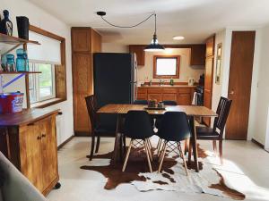 a kitchen with a dining room table and chairs at Woods Bay Get-A-Way in Bigfork