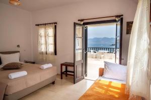 a bedroom with a bed and a view of the ocean at Pelagos Seafront Accommodation - George in Myrties