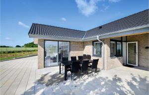 a patio with a black table and chairs at Three-Bedroom Holiday Home In Sydals in Sarup