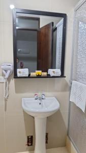 a bathroom with a sink and a mirror at ANDINO HOTEL MACHUPICCHu in Machu Picchu