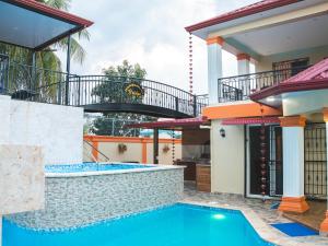 a pool in the backyard of a house at Welcome to Villa D’Mirella! in Santiago de los Caballeros