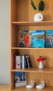 a book shelf with books and a red mushroom at City view apartments 3’ in Serres