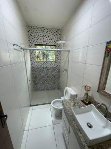 a bathroom with a shower and a toilet and a sink at Sítio Maravilha Parracho e Sonja (Casa Pé Na Areia) in Arraial d'Ajuda