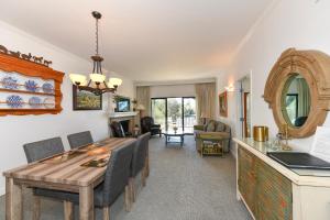 a dining room and living room with a table and chairs at Charming 2 bd Condo at Silverado in Napa