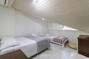 En eller flere senger på et rom på Triplex em condomínio próximo da Lagoa ARC003